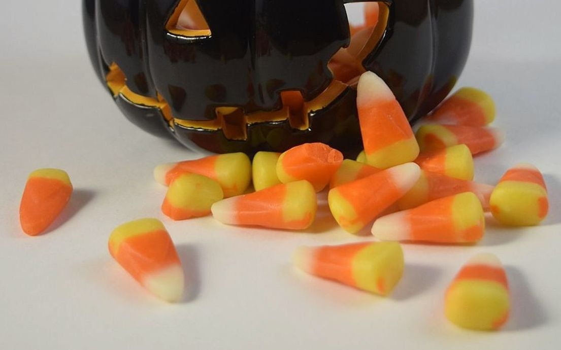 Colourful gummy candy arranged in a clear glass jar