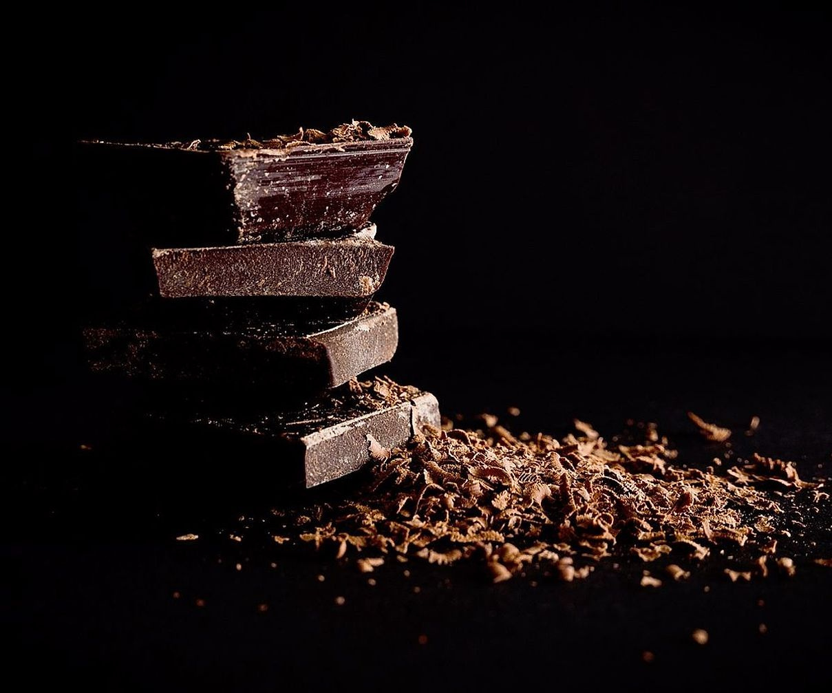 Artisan hands crafting chocolate bonbons with precision